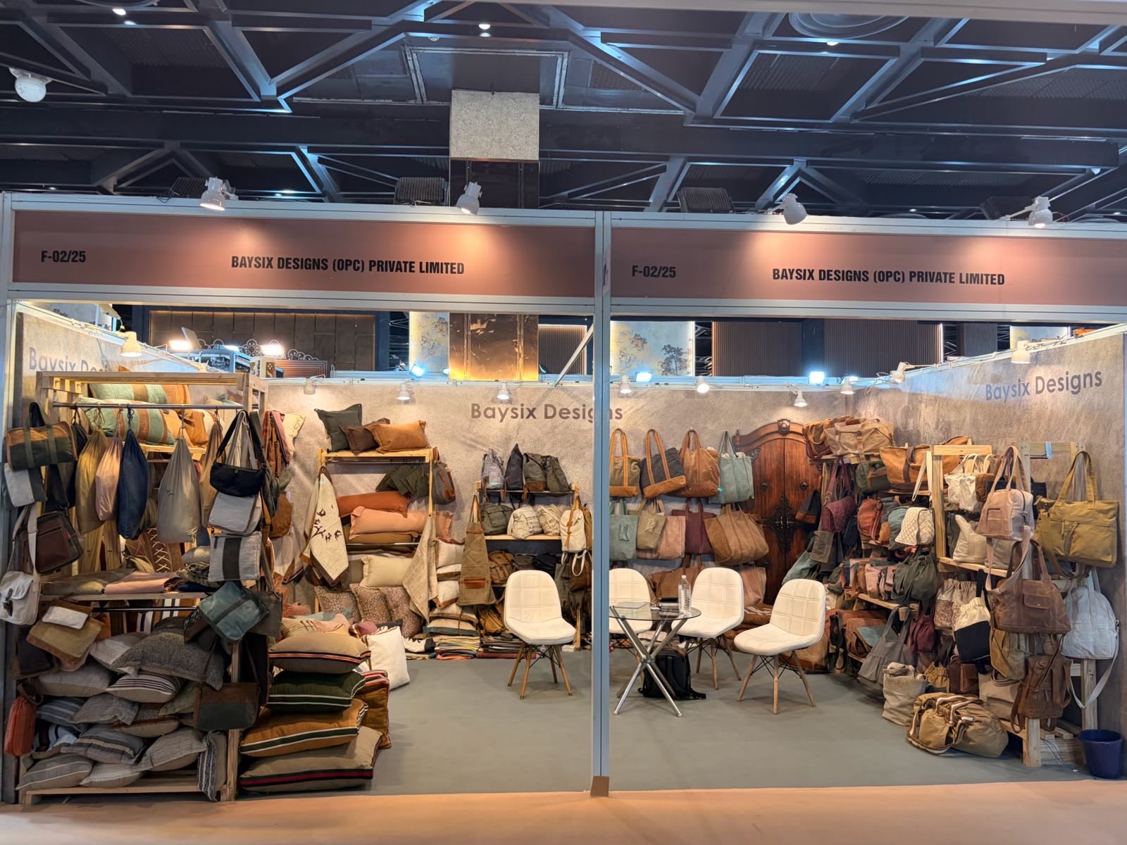 Baysix Designs (OPC) Private Limited exhibition stand displaying leather bags and cushions